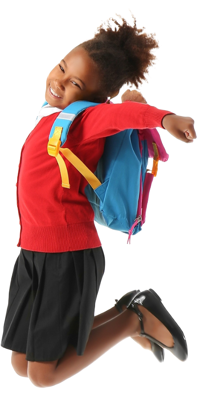 A very happy girl in school uniform jumping for joy.