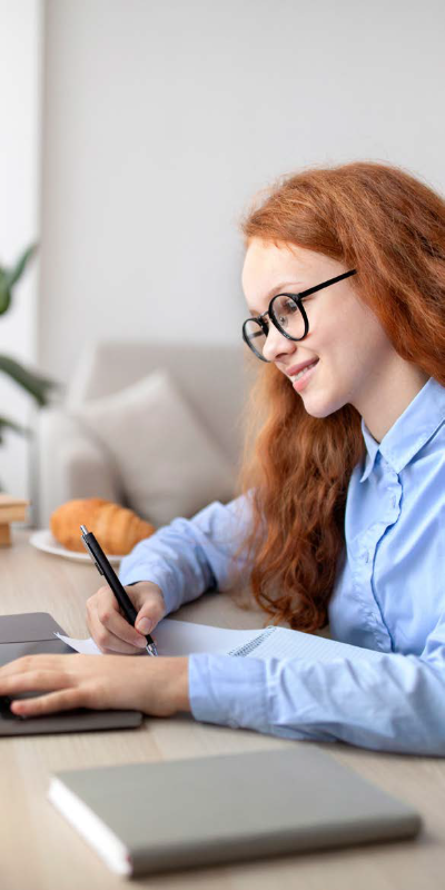 a secondary pupil doing homework at a desk.