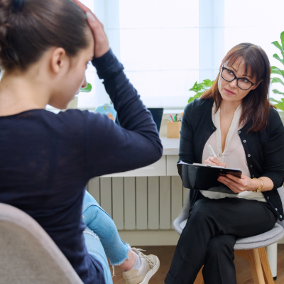 A worried teenage pupil speaks to a specialist teacher.