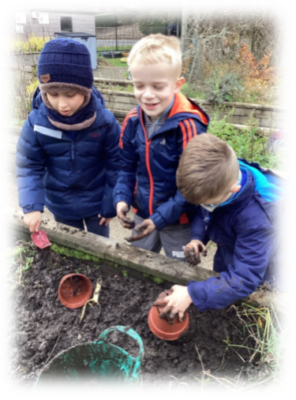 Three pupils working in the garden