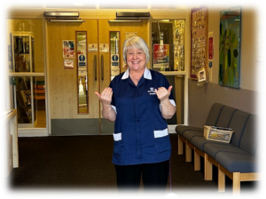Joan, Facilities Assistant, welcoming pupils.