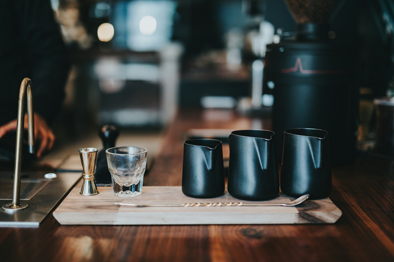 Pouring jugs and a glass on a bar