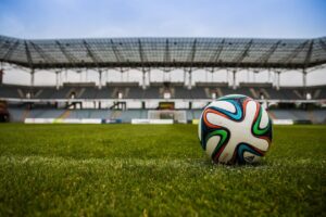 Football on a pitch. Photo by Pixabay via. Pexels.