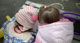 two pre school children learning together using a mobile device.