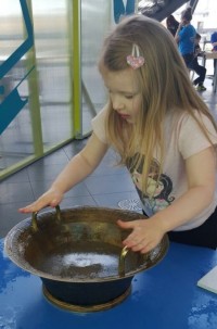 Taylor made sound waves by rubbing her wet hands on the handles to make a squeaky sound. It made the water fly everywhere!