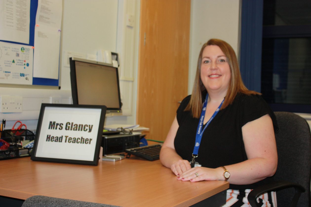 Mrs Glancy sitting at her desk.