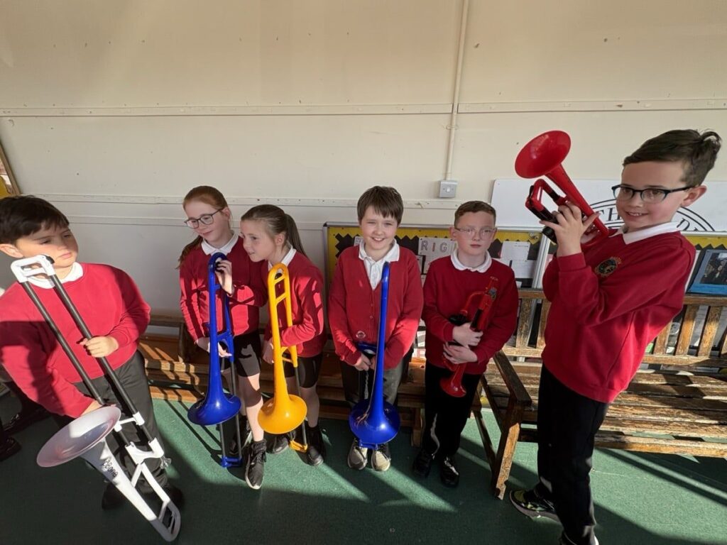 six children with trumpets & trombones