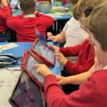 Pupils working on ScratchJr in the classroom