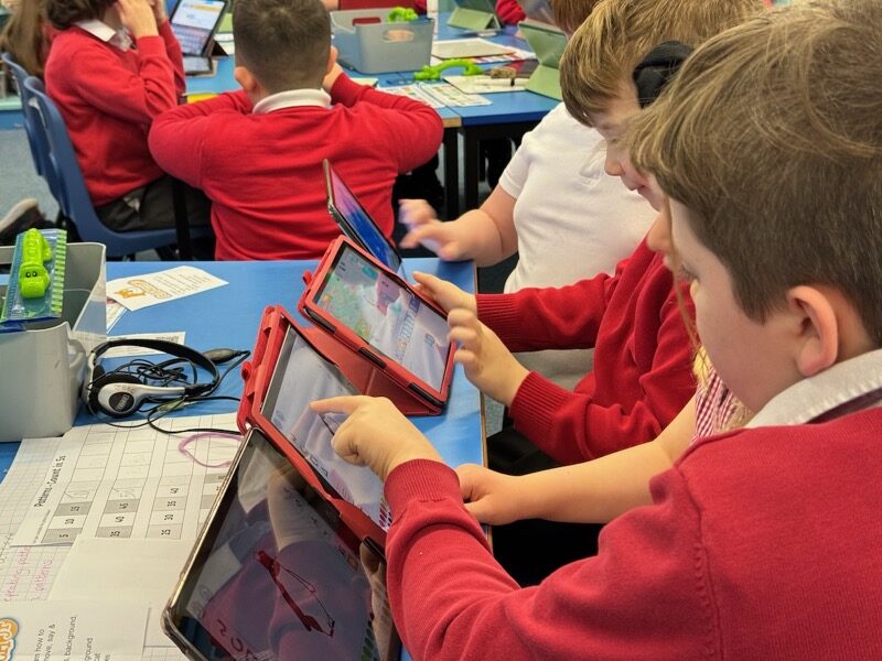Pupils working on ScratchJr in the classroom
