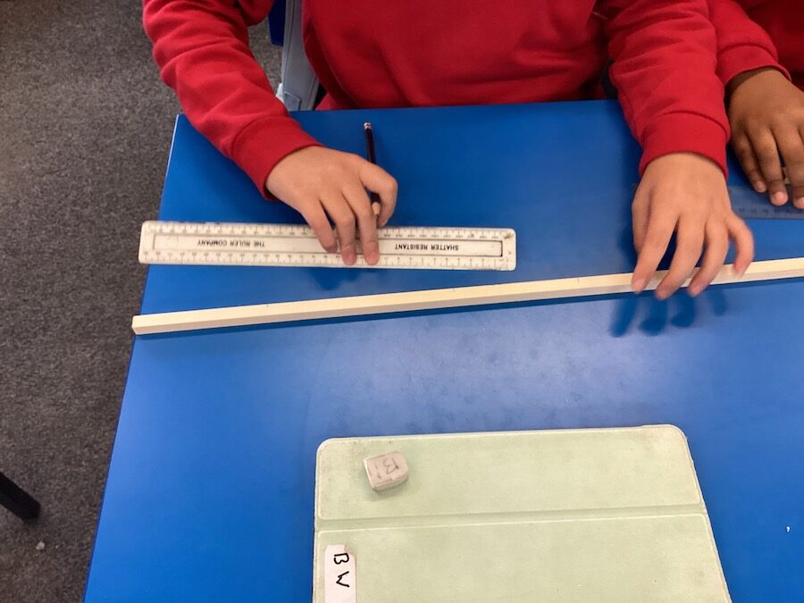 Child measuring wood