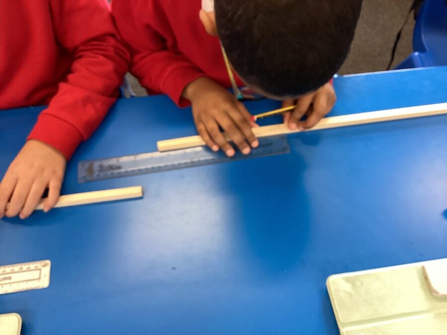 Child measuring wood