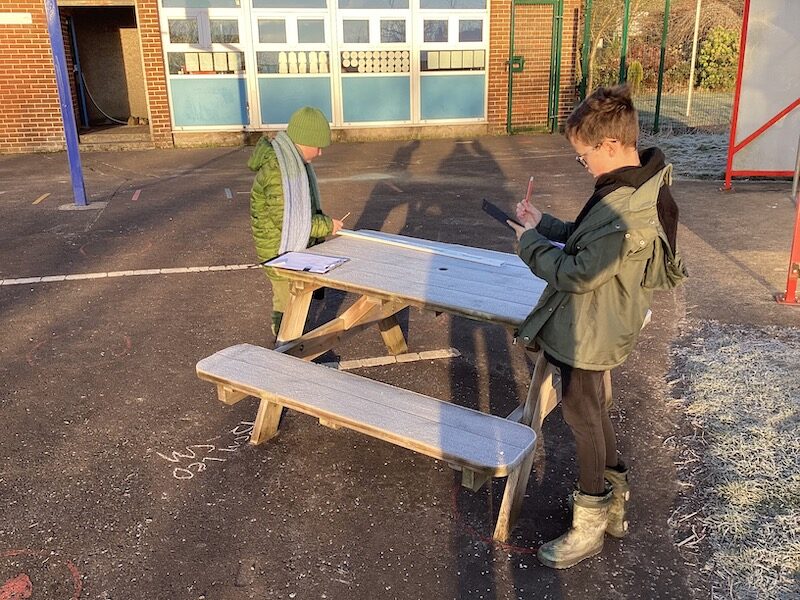 Children measuring in the playground