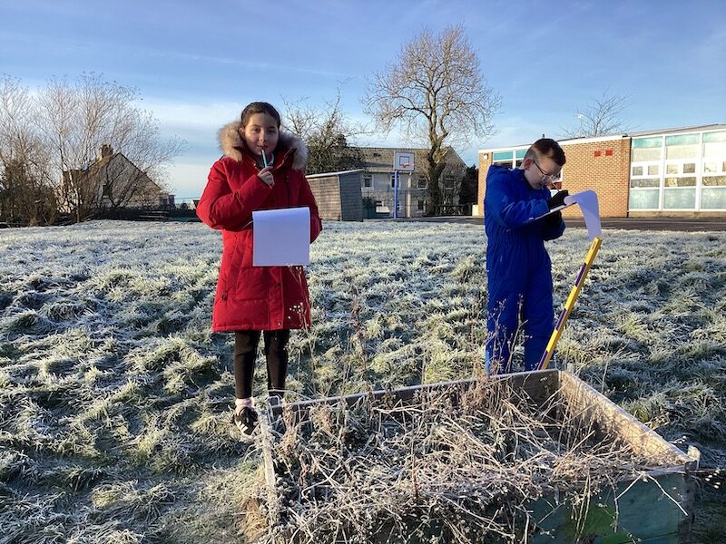 Children measuring in the playground