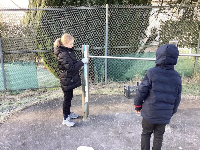 Children measuring in the playground