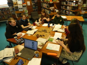 Students playing D&D in a school library